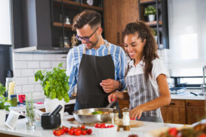 couple having fun cooking dinner